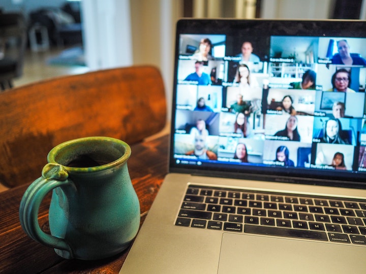 A laptop showing an online meeting