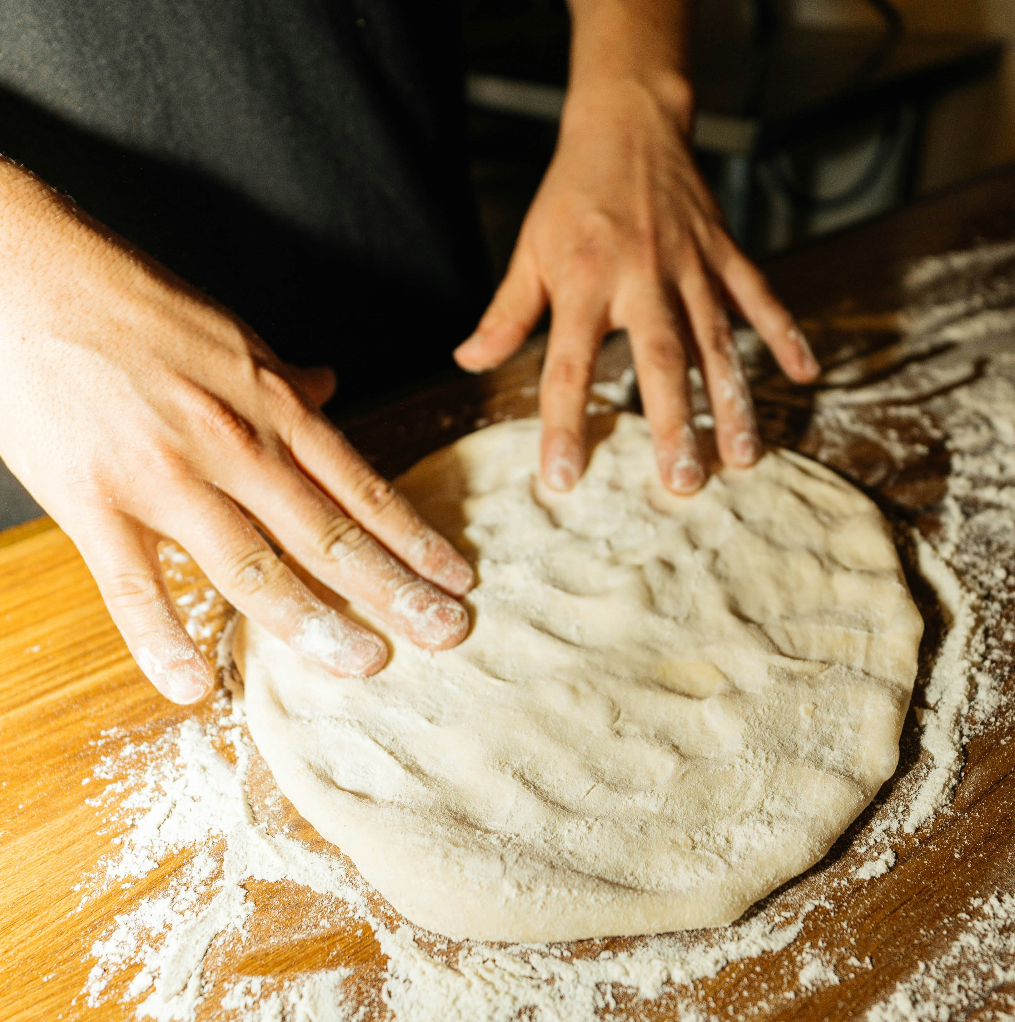 hand kneading pizza dough